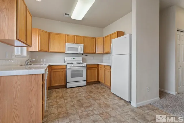 a kitchen with a white cabinets and white appliances