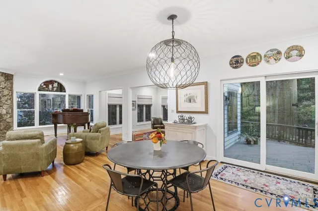 a living room with furniture chandelier and a large window