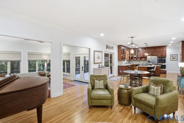a view of a living room filled with furniture and a view of kitchen