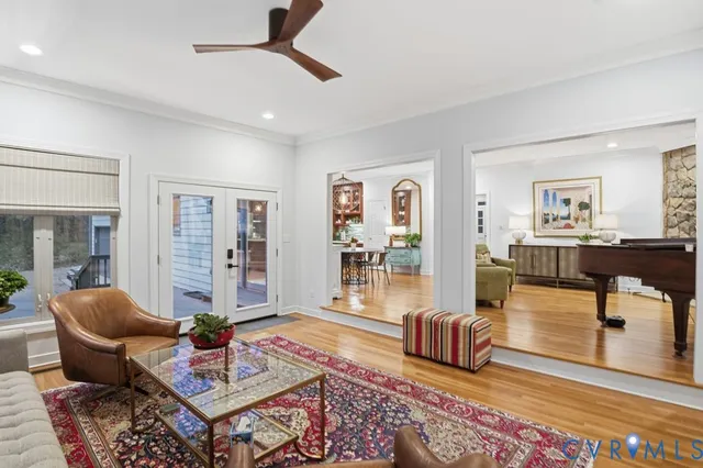 a living room with furniture and wooden floor
