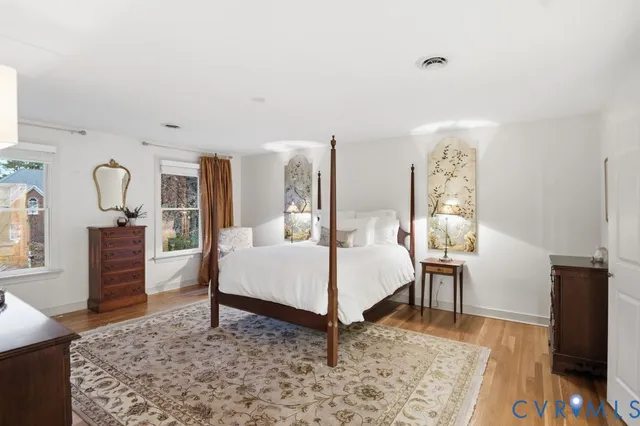 a living room with furniture rug and wooden floor