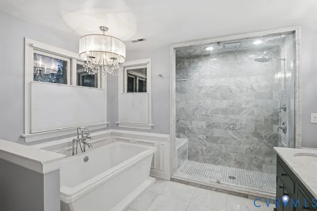 a bathroom with a bathtub and a shower