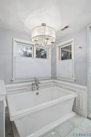 a bathroom with a bathtub and a mirror