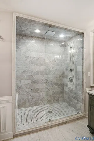 a bathroom with a glass shower door