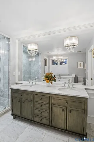 a bathroom with a granite countertop sink mirror and double