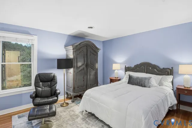 a bedroom with a bed and a chair