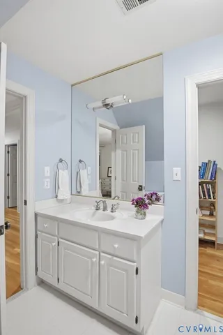 a bathroom with a sink vanity granite and a mirror