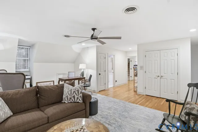 a living room with furniture and a ceiling fan