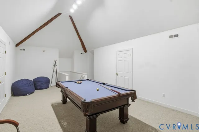 a room with pool table and windows