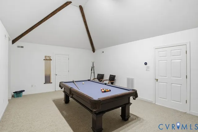 a room with pool table and windows