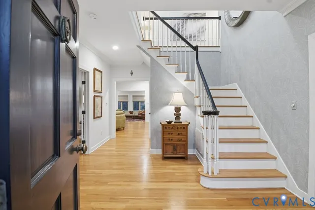 a view of entryway and hall with wooden floor