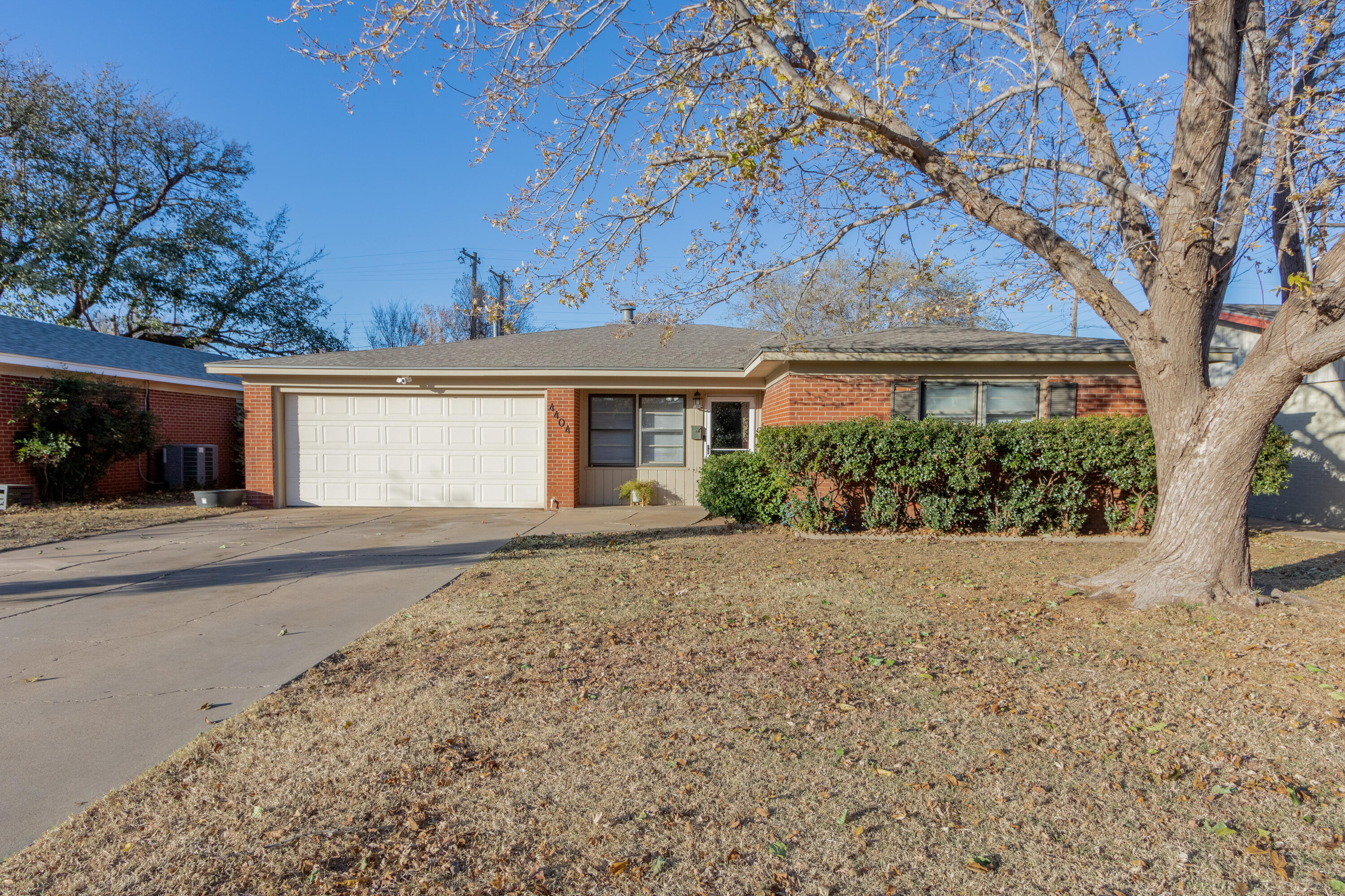 front view of a house with a tree in front