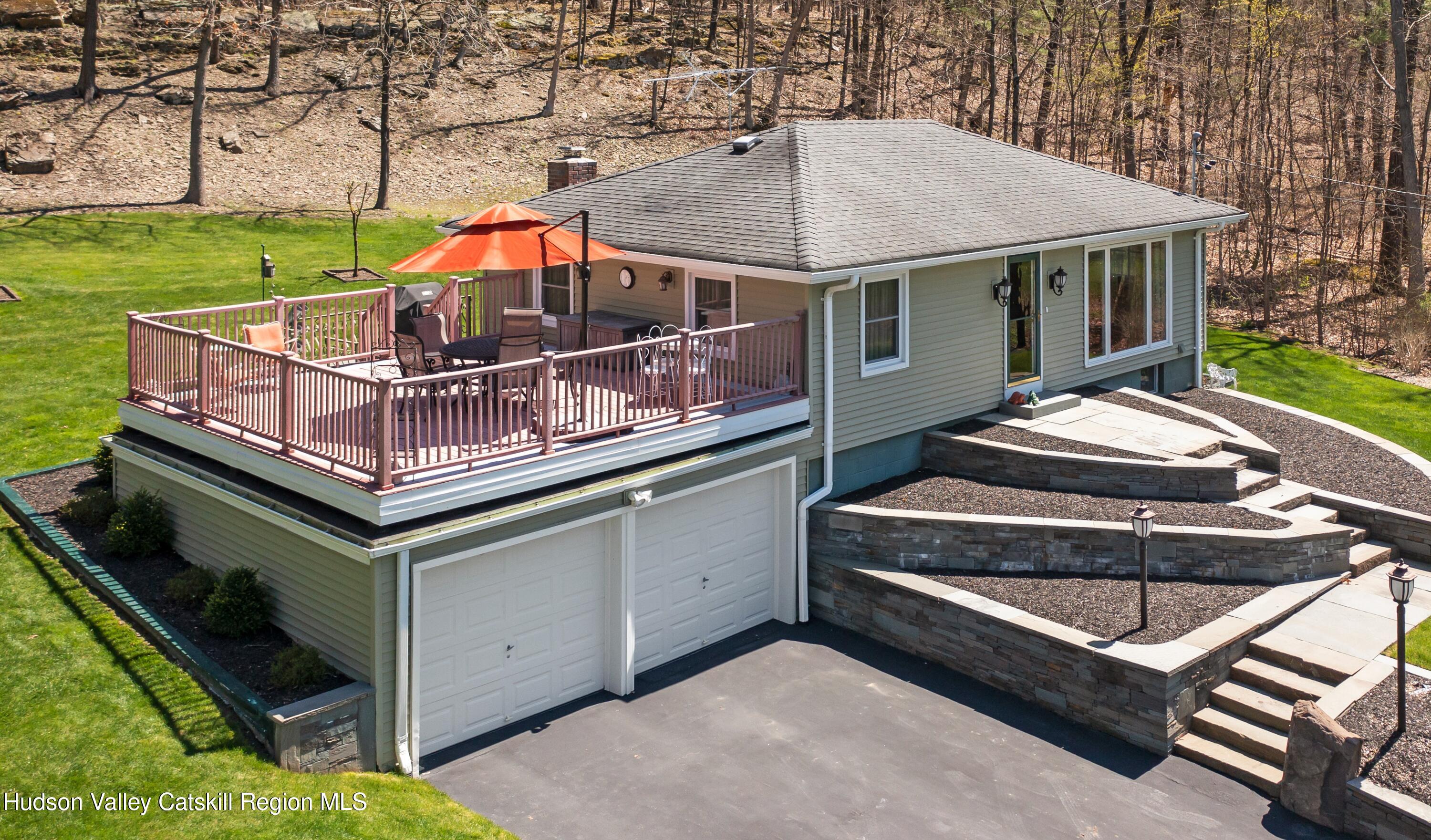 a roof deck with table and chairs under an umbrella