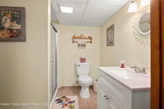 a bathroom with a sink mirror and toilet