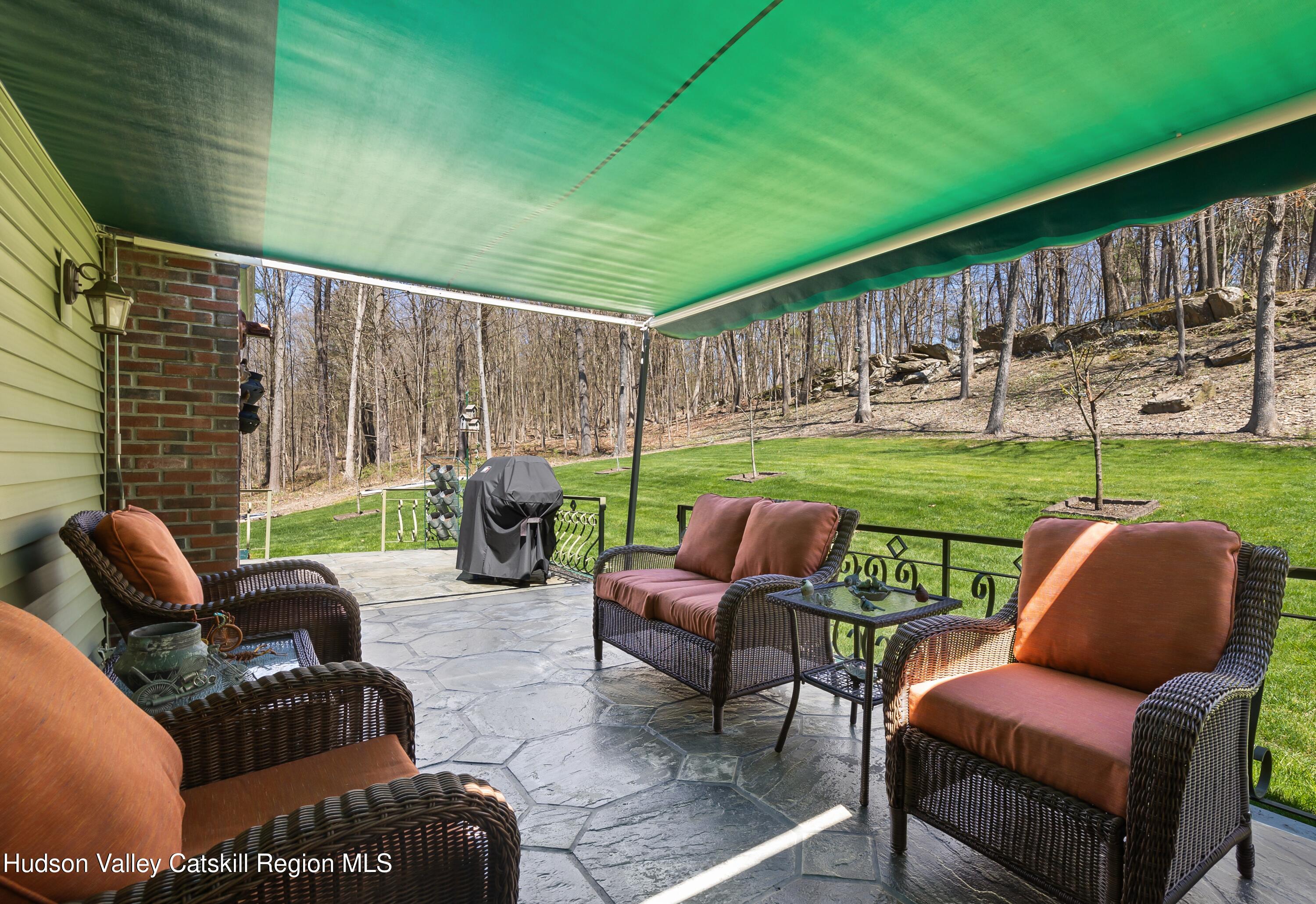 412 Vosenkill Road Athens, NY 12015 - Photo 21 of 43 a view of a patio with couches chairs potted plants and a yard