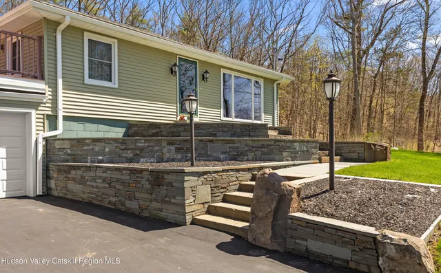 a view of a house with backyard and sitting area