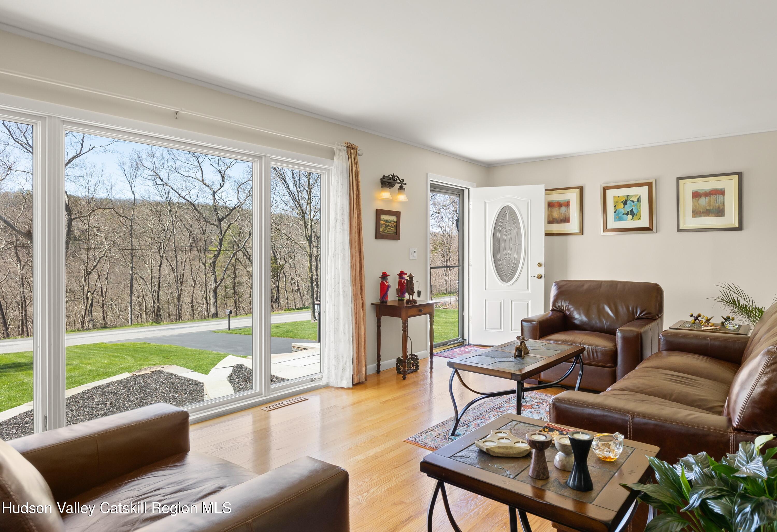 412 Vosenkill Road Athens, NY 12015 - Photo 3 of 43 a living room with furniture and a floor to ceiling window