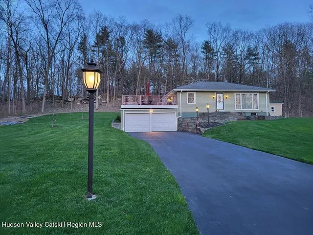 a view of a house with a backyard