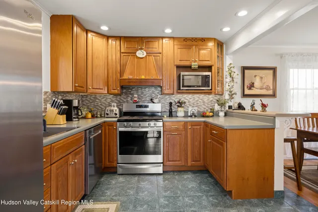 a kitchen with stainless steel appliances granite countertop a stove a sink dishwasher and a refrigerator