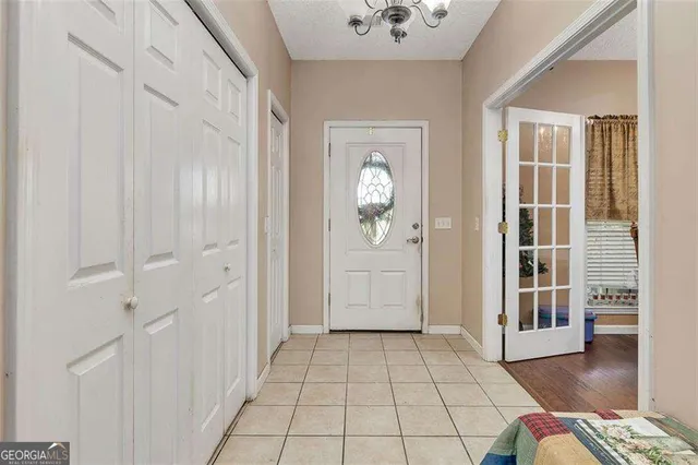 a bedroom with bed a couch and a window