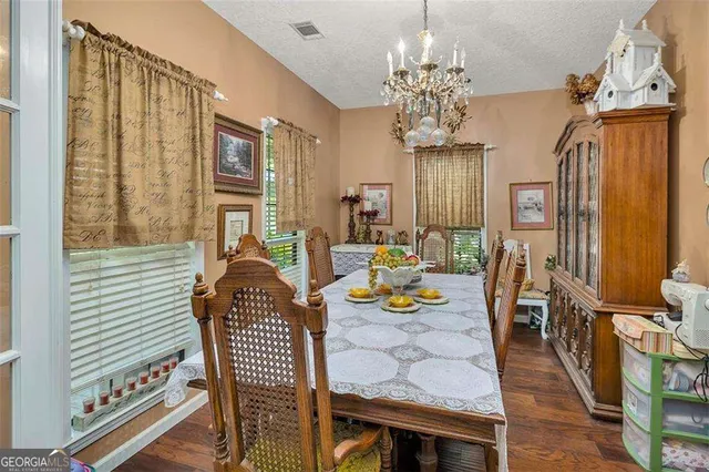 a living room with furniture kitchen view and a window