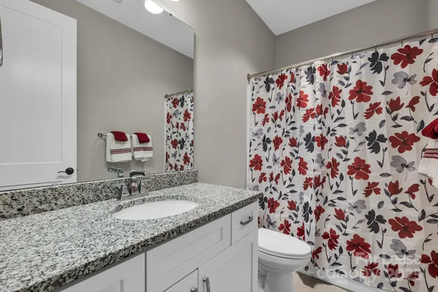 a bedroom with a bed and chair