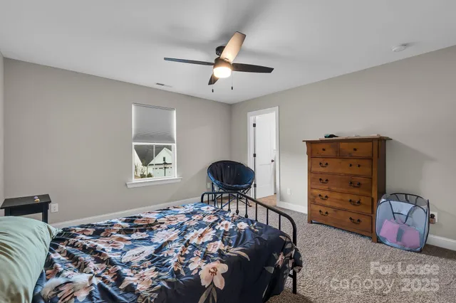 a bedroom with a bed and a couch