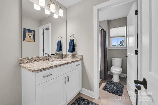 a spacious bedroom with a bed and ceiling fan