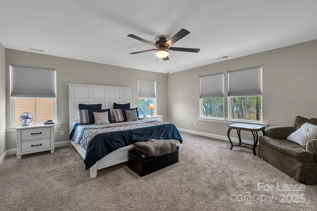a bathroom with a granite countertop sink a mirror and a shower
