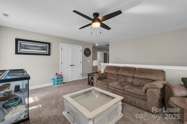 a view of living room with furniture and wooden floor