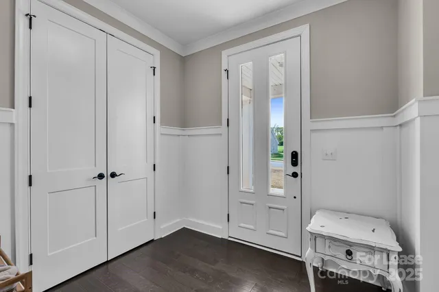 a view of kitchen with refrigerator and cabinets