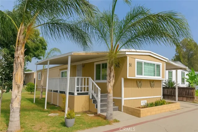 a house with palm tree in front of it