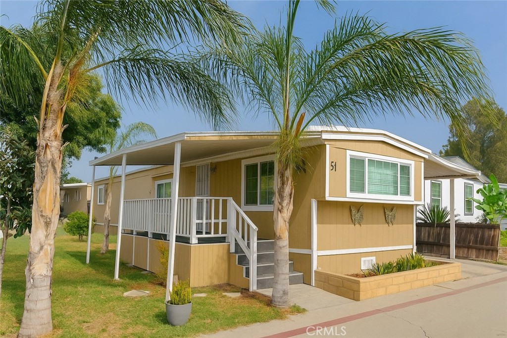 a house with palm tree in front of it