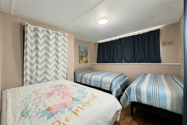 a bedroom with a bed and a large mirror