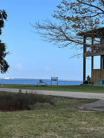 a view of a yard next to a lake view