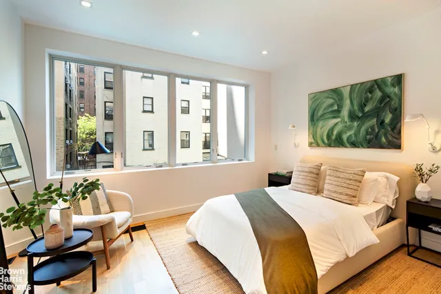 a bedroom with a bed and a chair