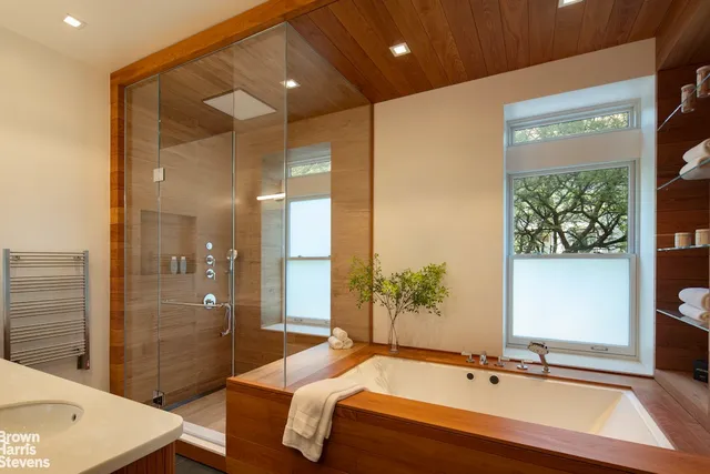 a spacious bathroom with a bathtub and a sink