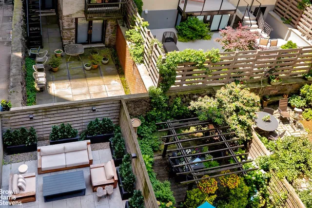 a backyard of a house with outdoor seating