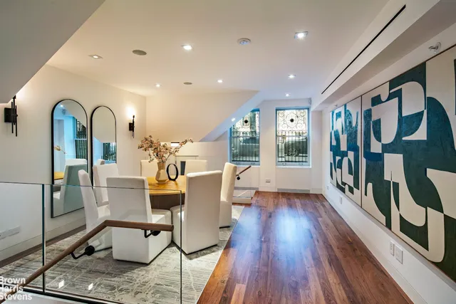 a view of living room with furniture and wooden floor