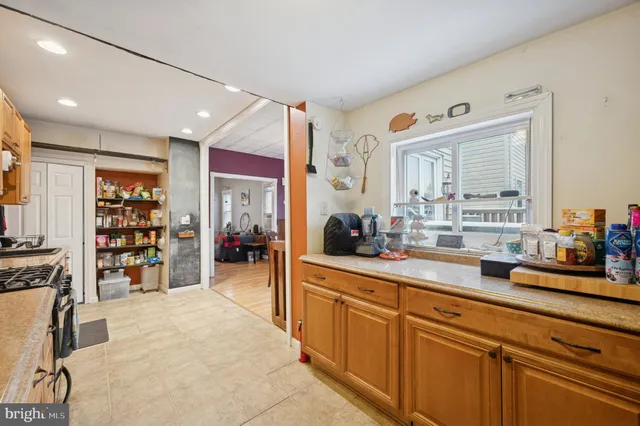 a open kitchen with stainless steel appliances granite countertop a refrigerator and a sink