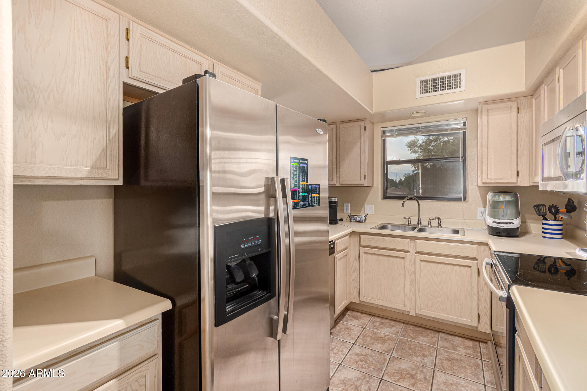 1800 West Elliot Road, Unit 227 Chandler, AZ 85224 - Photo 7 of 27 a kitchen with a sink stove and refrigerator