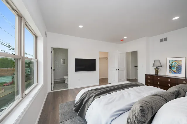 a bedroom with a bed and a flat screen tv