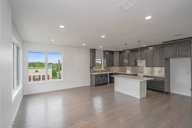 a kitchen with a refrigerator and a stove top oven