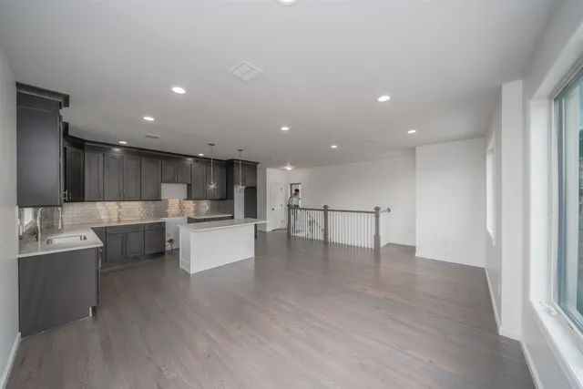 a view of kitchen with stainless steel appliances refrigerator oven and cabinets