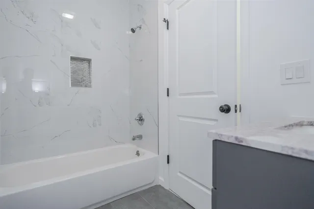 a bathroom with a bathtub and a sink