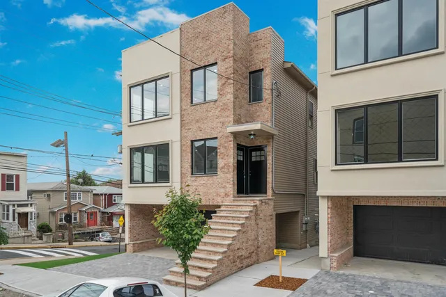 a front view of a building with a garden