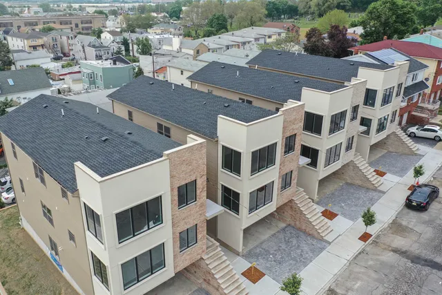 an aerial view of residential houses with parking space