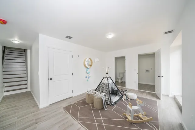 a view of a livingroom with wooden floor and windows