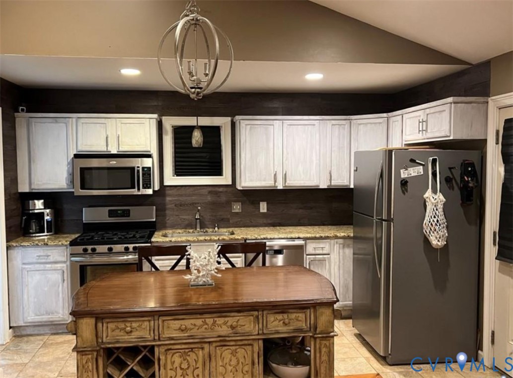 1151 Cartersville Road Cartersville, VA 23027 - Photo 3 of 14 a kitchen with stainless steel appliances granite countertop a refrigerator a stove a microwave oven a sink with island and chairs