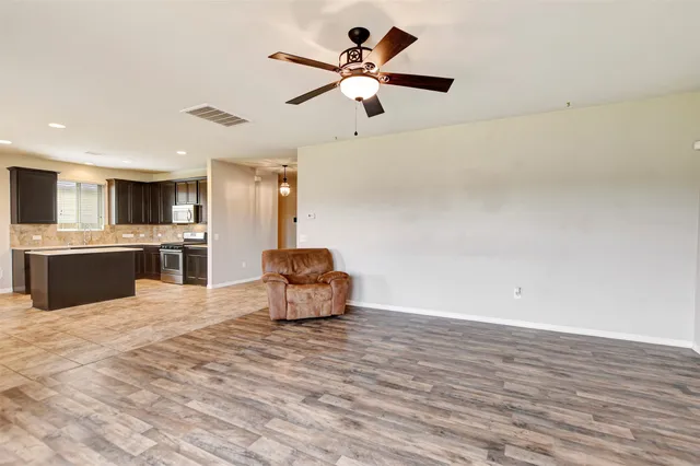 a view of livingroom with hardwood floor and a ceiling fan